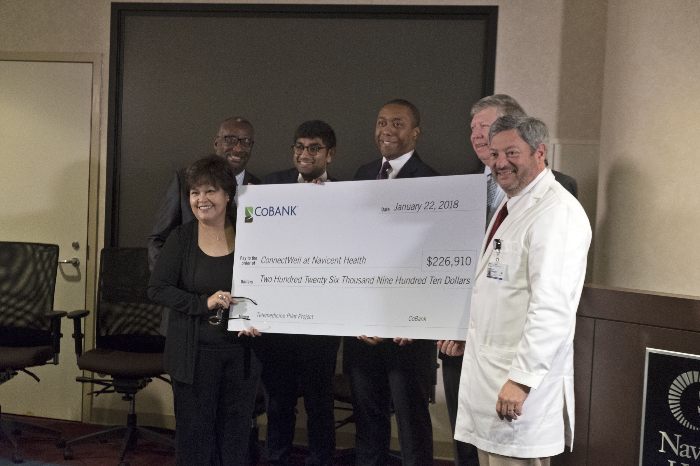 Navicent Health leaders stand with check donation from CoBank