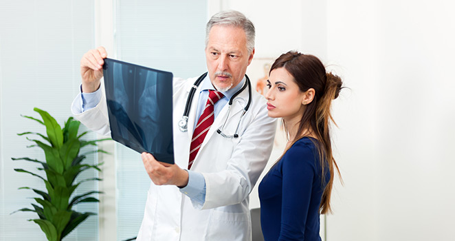 Doctor shows a woman some X-ray results