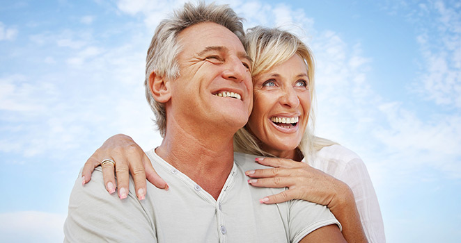 Older couple smiling and looking into the distance