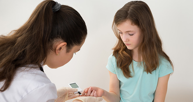 Young girl is getting her blood tested by a doctor