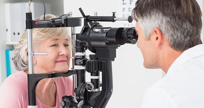 Doctor examines an elderly woman's eyes