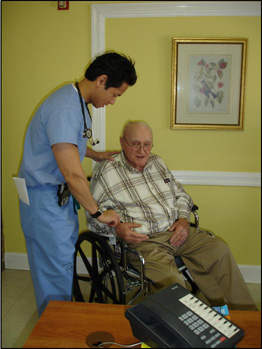 Residenthelps an elderly man in a wheel chair