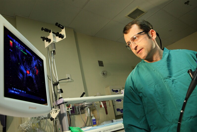 Dr judah looking at a monitor in the lab