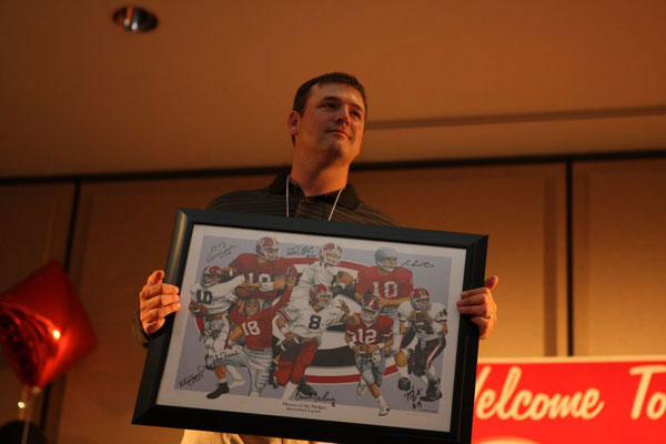 Auctioning off a signed NFL poster at the 25th Silver Anniversary Children's Hospital Golf Classic