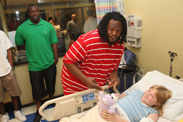 A man posing silly with a young patient
