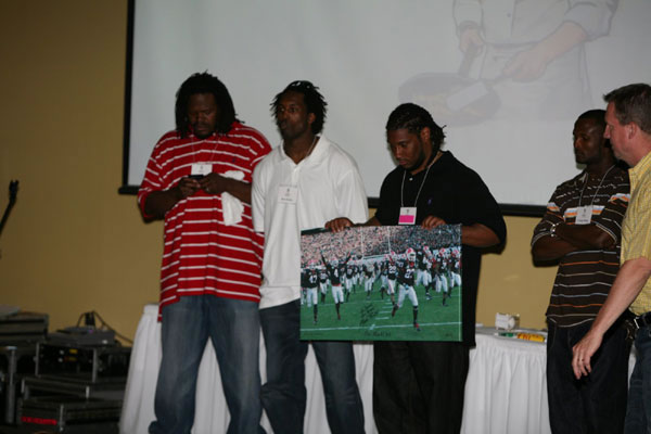Georgia Bulldogs players present a signed poster at the 25th Silver Anniversary Children's Hospital Golf Classic