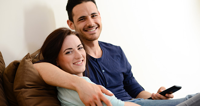 Young couple sitting together on a couch