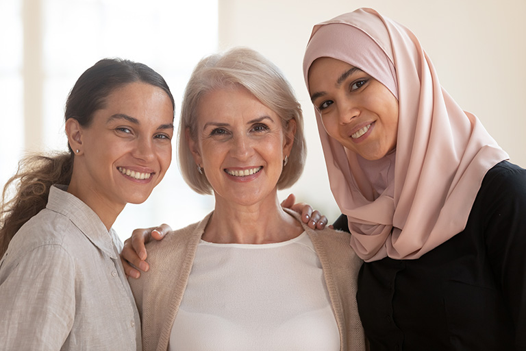 Three women are smiling