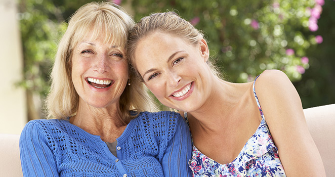 Mother and daughter embracing and smiling