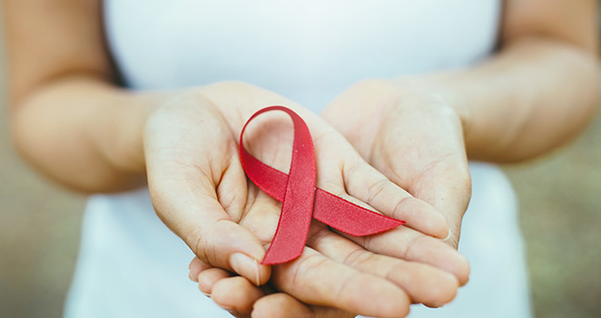 Woman holding a red ribbon