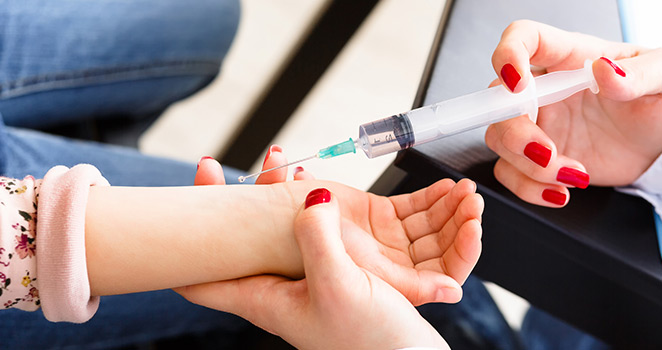 Young girl getting a shot in her arm