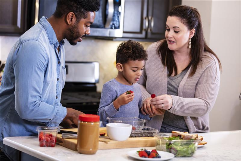 Younger parents talking to their son