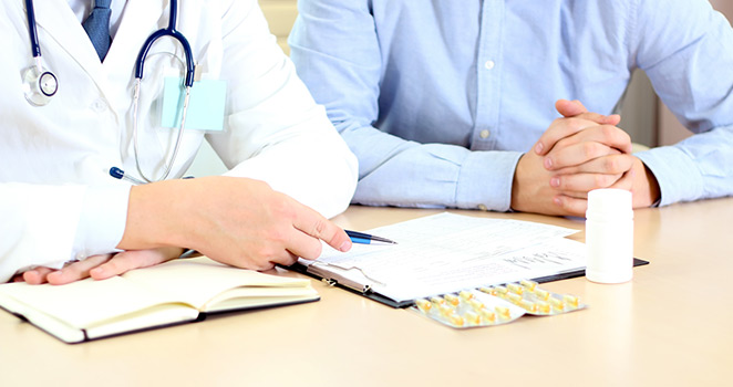 Doctors sitting at a meeting having a discussion