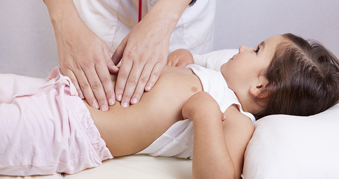 Small girl getting an abdominal exam