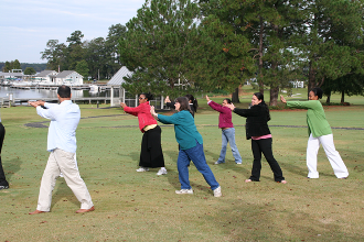 Residents learn some stretching techniques in an outside class