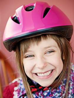 Girl in a bike helmet smiling