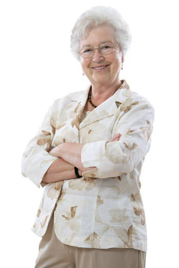 Elderly woman standing and smiling with her arms crossed