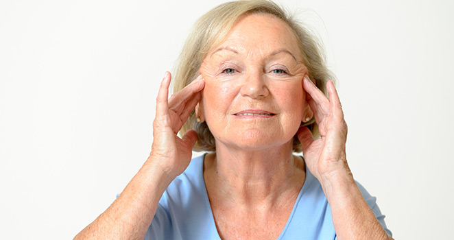 Older woman rubbing her head