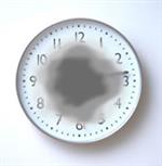 Macular degeneration exmple, shows a clock with a darkened, blurry center