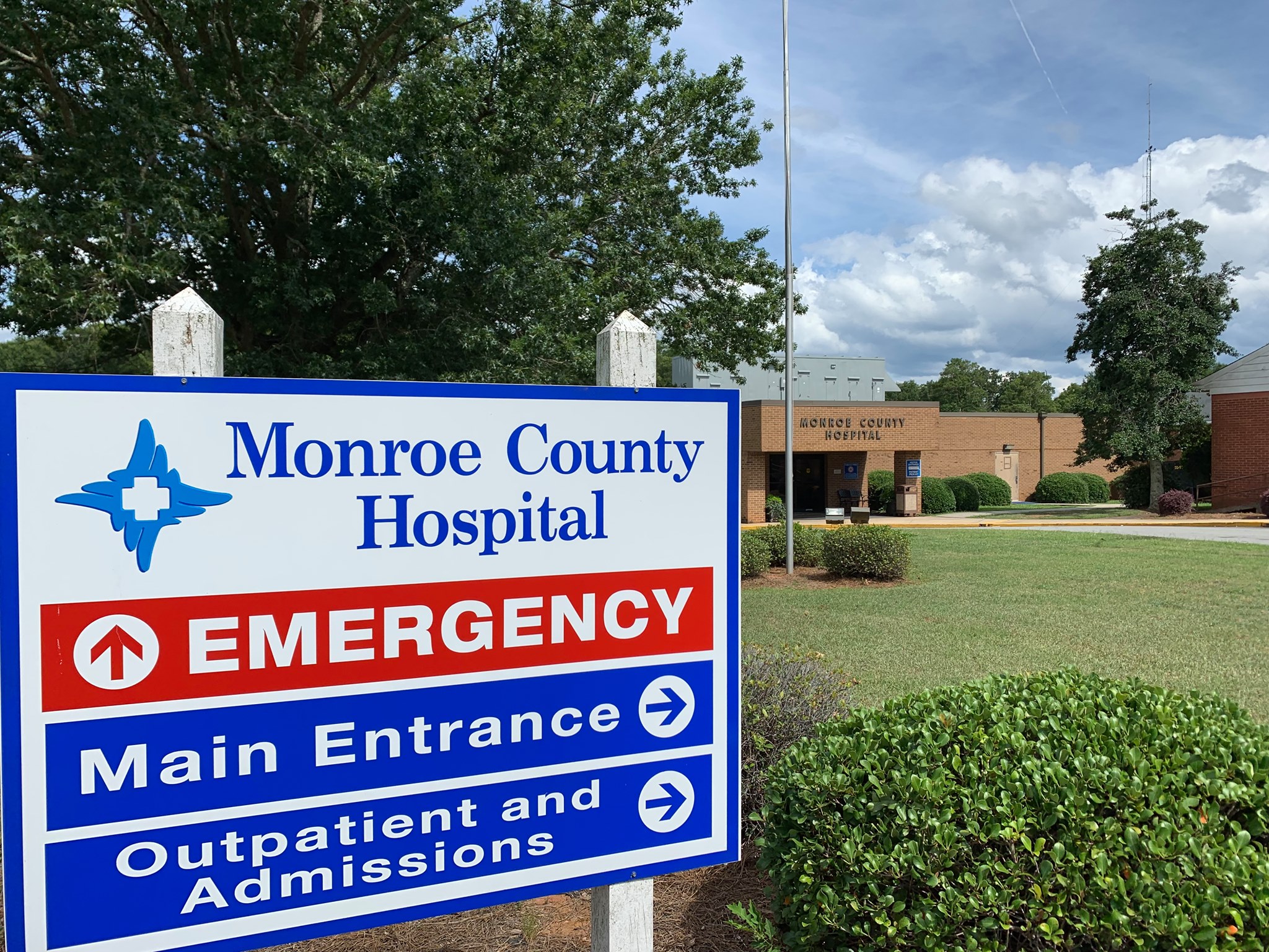 Monroe County Hospital entrance sign with building in the background