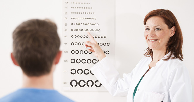 Doctor giving a chart reading eye test