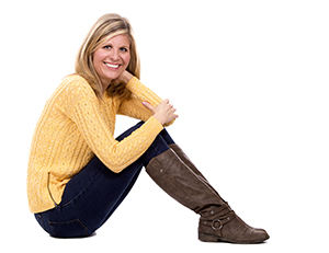 Middle aged woman sitting on the floor smiling