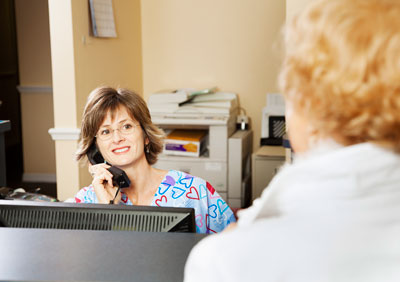 Office receptionist on the phone.