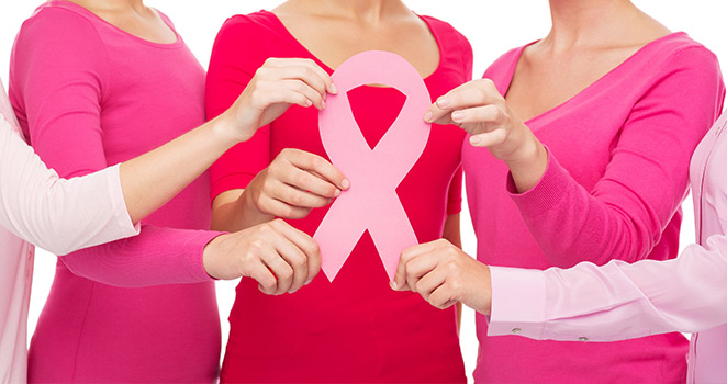  Four women holding a Cancer Awareness ribbon