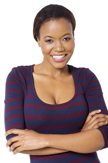 Young woman standing and smiling with her arms crossed
