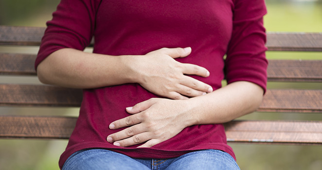 Woman holding her stomch in pain