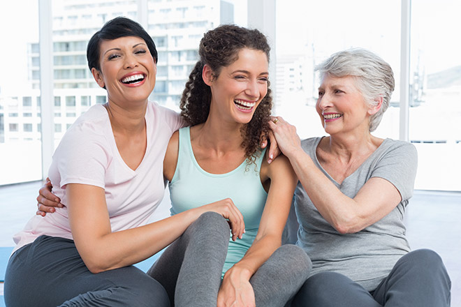 Three woman sitting together and smiling