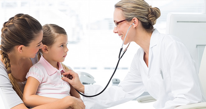 Doctor listens to a young girls heart